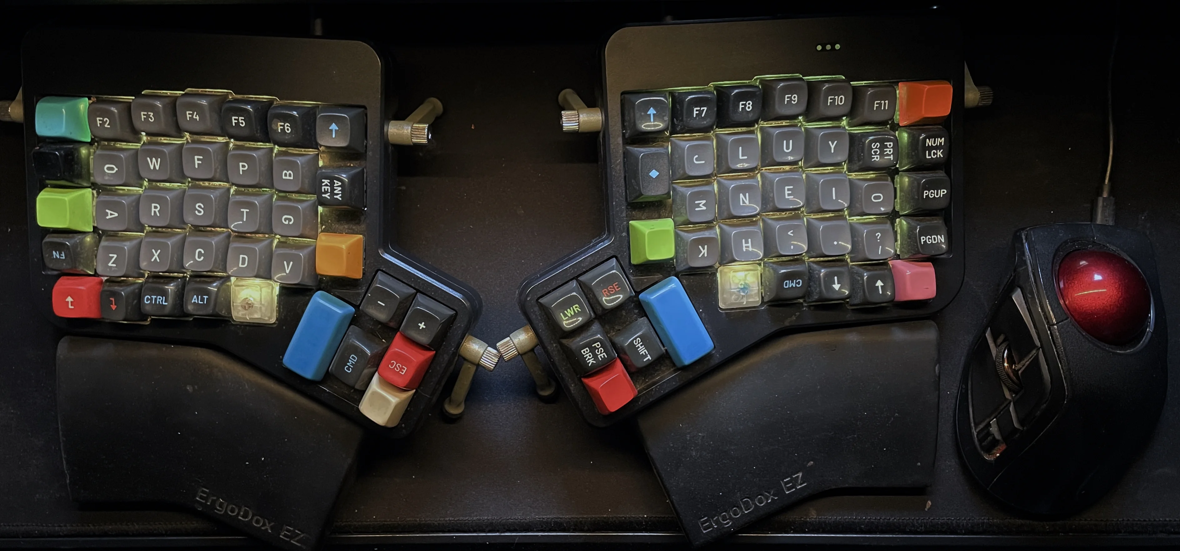 Photograph of keyboard and trackball on desk.